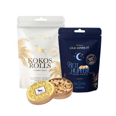 Veggie-Selektion von LILA LOVES IT mit Kokos Rolls, Betthupferl mit Kamille, Lavendel und Passionsblume sowie einer geöffneten Dose mit kleinen gebackenen Hundesnacks.