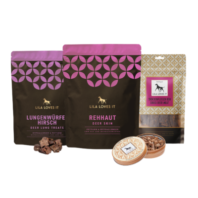 Produktset von LILA LOVES IT mit verschiedenen natürlichen Wild-Snacks für Hunde, darunter Lungenwürfel vom Hirsch, Rehhaut, getrocknetes Rehfleisch und Wild-Leckerlis in einer Dose.