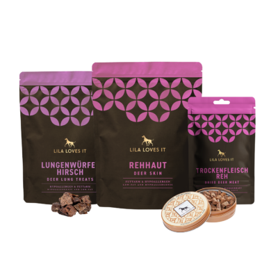 Produktset von LILA LOVES IT mit verschiedenen natürlichen Wild-Snacks für Hunde, darunter Lungenwürfel vom Hirsch, Rehhaut, getrocknetes Rehfleisch und Wild-Leckerlis in einer Dose.